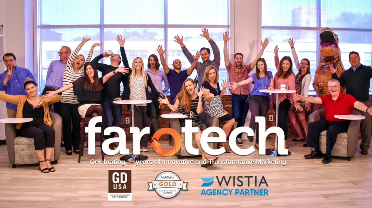 Farotech Digital Marketing Agency employees gather against a window, their hands in the air, covered by the Farotech logo.