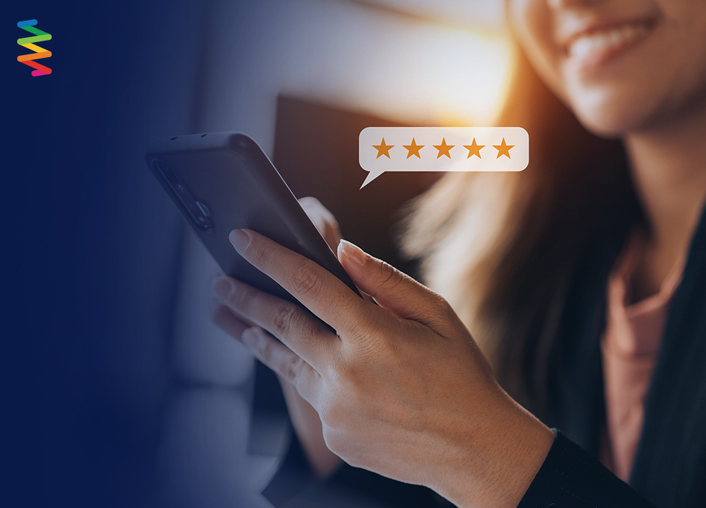 Woman showing customer lifetime value by adding a five star review for a company on her phone.