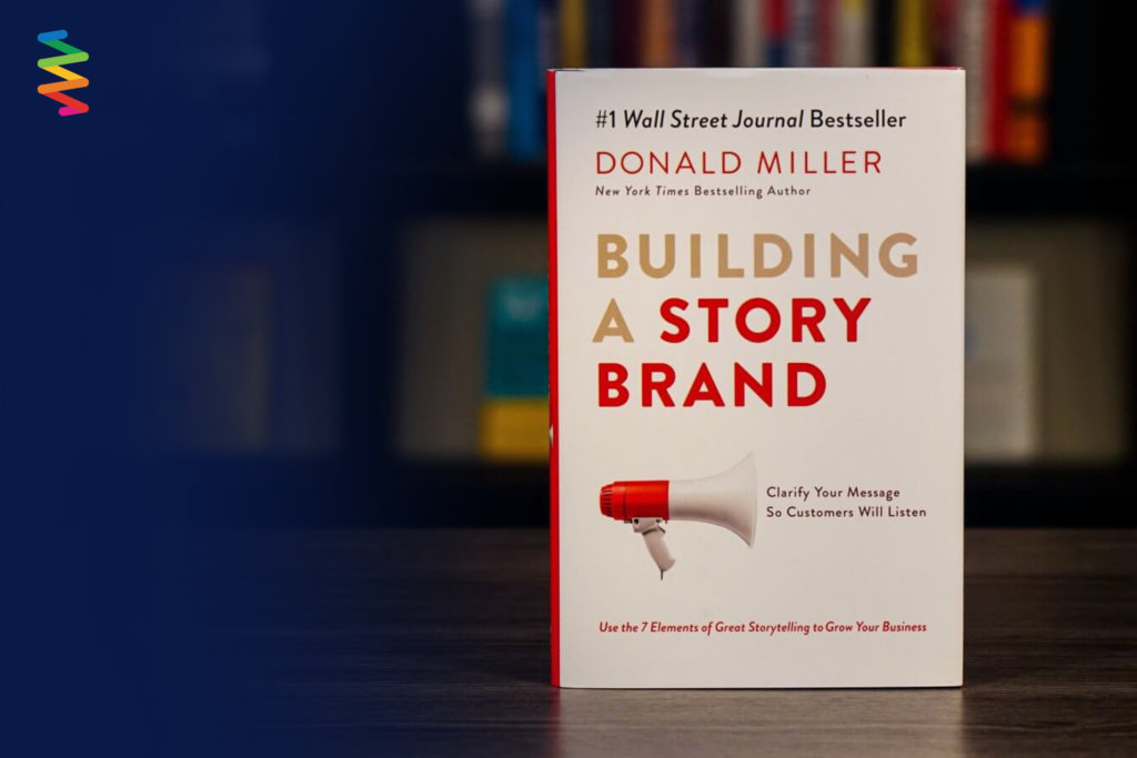 A picture of Donald Miller’s book Building a StoryBrand on a desk with blurred bookshelf in the background.